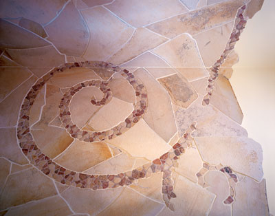 
Natural stone pervades the home. In the bathroom, small river stones spiral through limestone flagging. And at the living room hearth, granite abuts a native pecan floor from Texas Woods, a local mill that specializes in harvesting native, sustainable woods (www.texaswoods.com).
